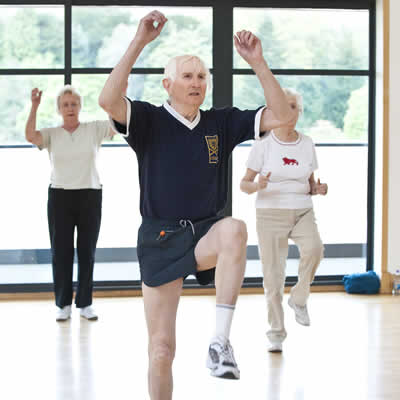 Group of older people doing an aerobics class