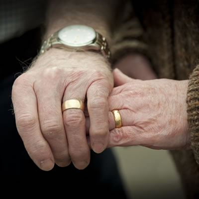 An older couple holding hands
