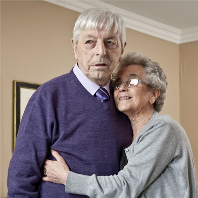 Older man and lady hugging