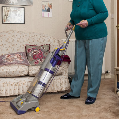 Mature lady hoovering