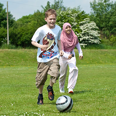 2 teenagers playing football