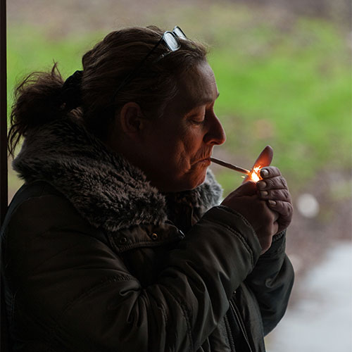 Person lighting up a cigarette