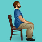 Man sitting upright in a chair, adopting good posture